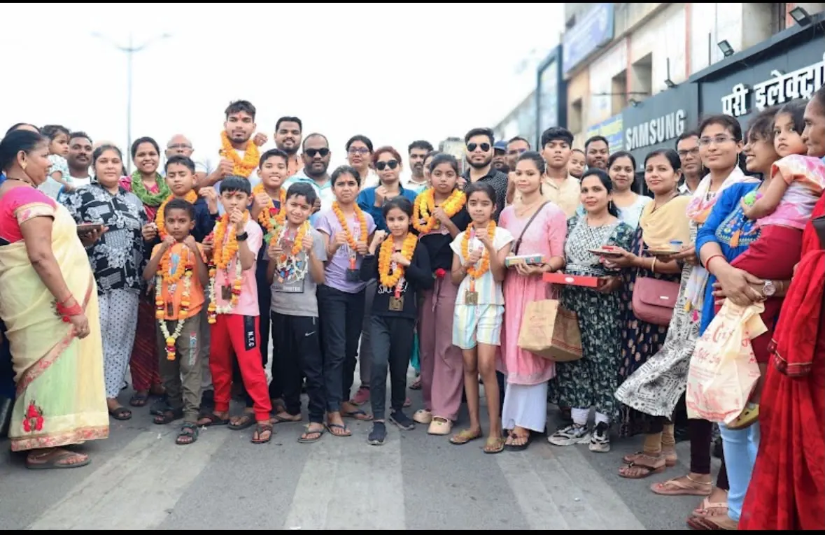Families and students celebrating with garlands after a championship